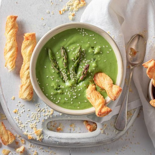 Vegan creamy asparagus soup as perfect starter in restaurant.