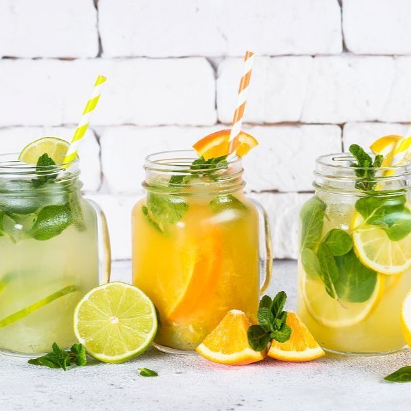 Summer drink. Lemonade, mojito and orange lemonade in mason jars. Brick wall background.