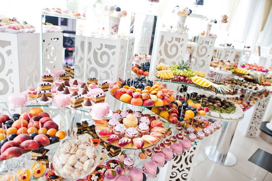 Beautiful wedding candy bar with sweets, fruits and food. Wedding banquet table